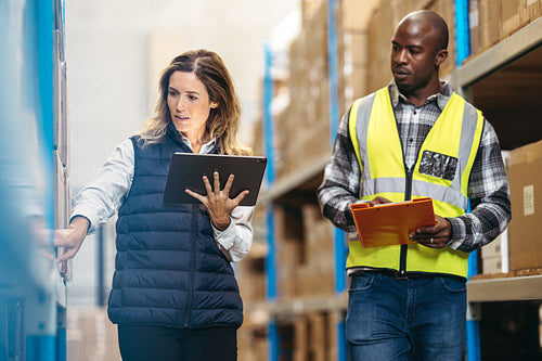 Warehouse workers doing stock control in a distribution centre