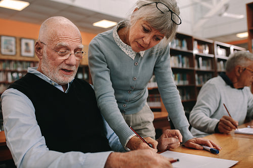 Close up of a university professor teaching an elderly man