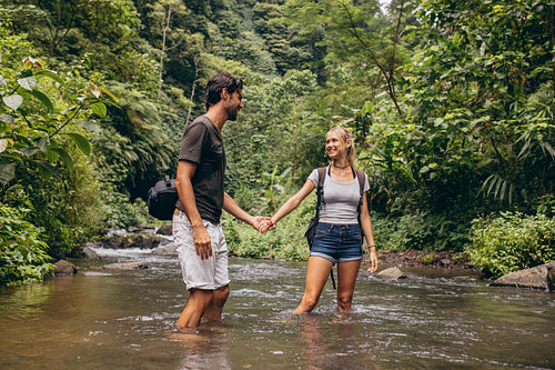 Loving young couple in forest stream