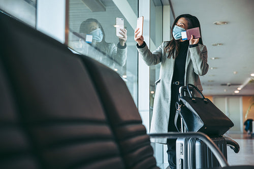 Traveler having a video call at airport waiting lounge