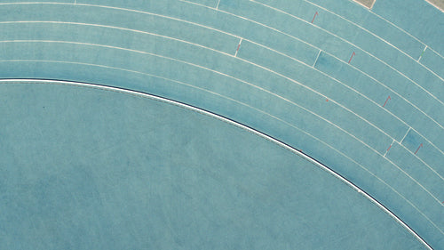 Female runner practicing on race track in stadium
