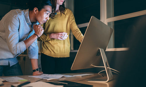 Business partners working late night at office