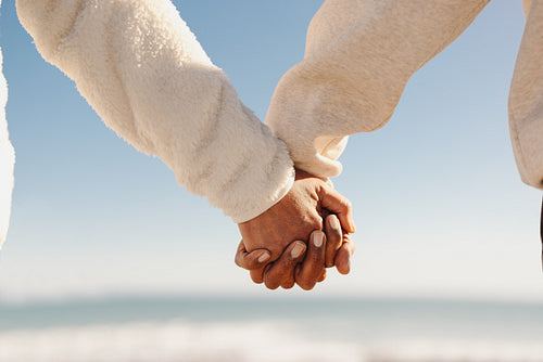 Mature couple holding hands at the beach