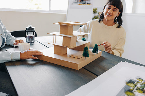 Collaborative team meeting for architecture model planning in a modern office.