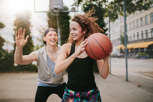 Teenage friends enjoying a game of streetball