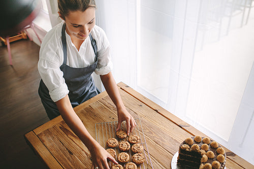 Female pastry chef preparing cookies