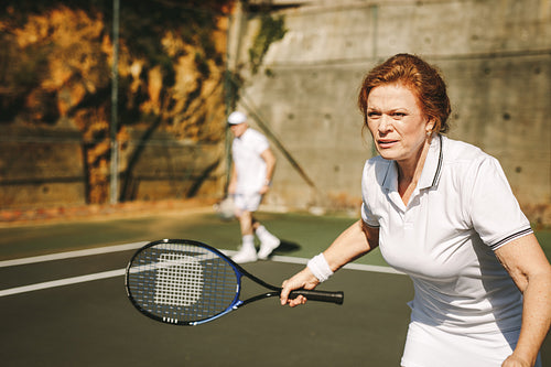Senior woman playing tennis