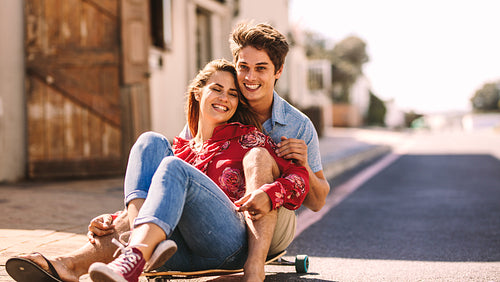 Couple enjoying a skateboard ride together on a street