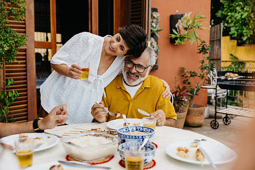 Brazilian senior couple enjoying a family churrasco barbecue outdoors