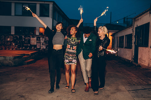 Group of friends enjoying out with sparklers