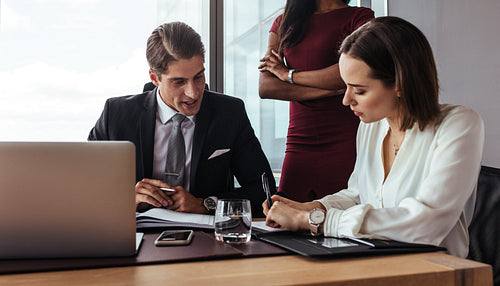 Boss dictating to assistant at office