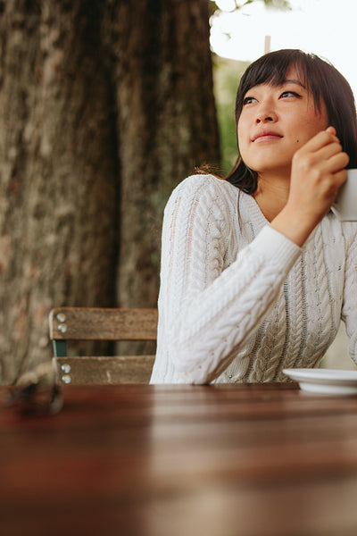 Young woman at cafe with a cup of coffee