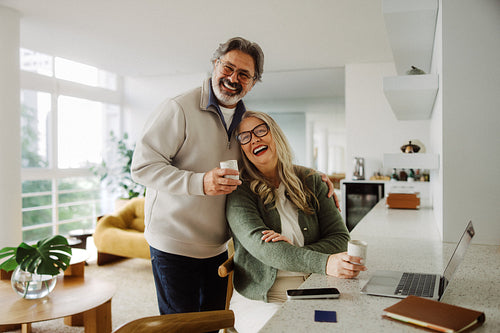 Happy senior couple shop online together at home