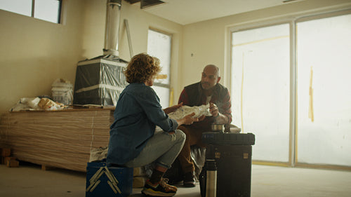 Taking a moment: Couple enjoys a lunch break during home renovation