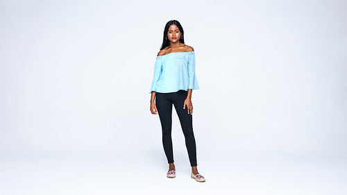 Young woman standing against white background