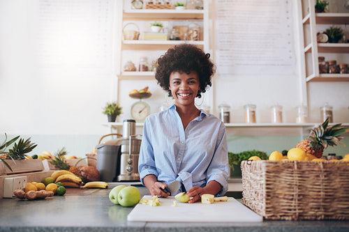 Young african woman working at juice bar