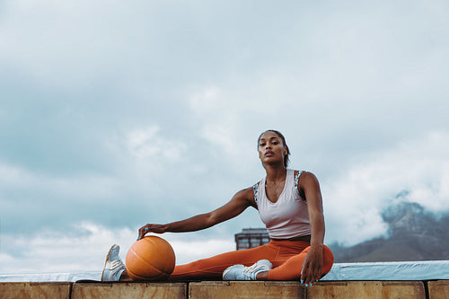 Athletic female taking break from workout on rooftop