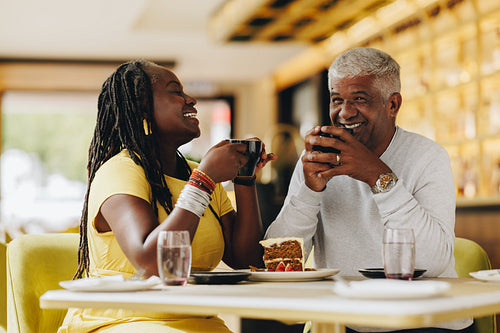 Happy senior couple having coffee together in a cafe