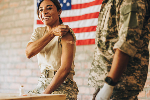 American servicewoman smiling happily after getting vaccinated
