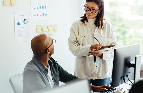 Business man talking to his manager in an office