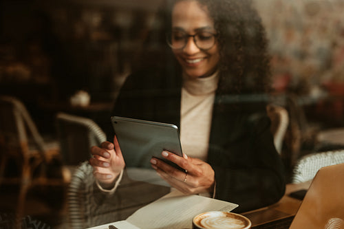 Businesswoman using digital tablet at cafe