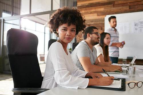 Confident businesswoman sitting at a business presentation