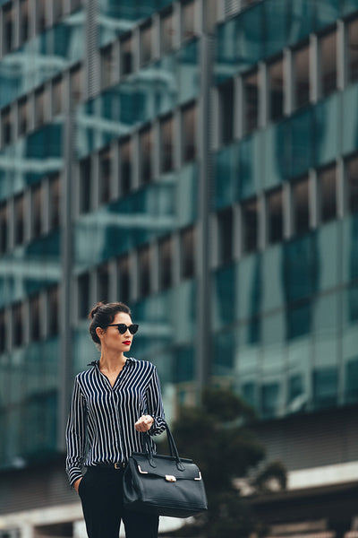 Businesswoman with handbag on the city street