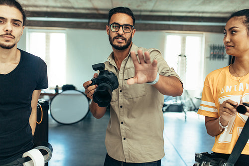 Photographer with his team during a photo shoot in a studio