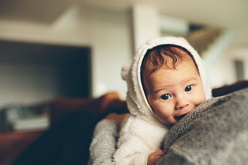 Cute little baby on his mother's chest
