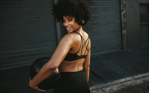 Woman resting after medicine ball workout