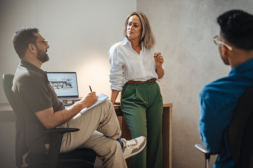 Group discussion at an architectural firm with a diverse team of professionals