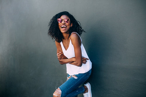 Portrait of a woman standing against a wall