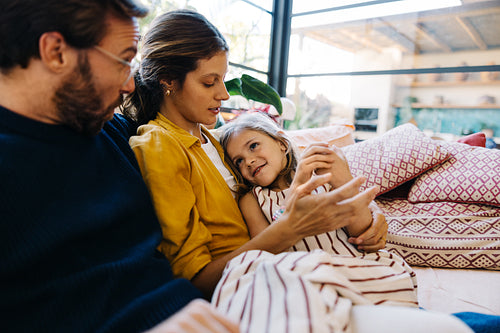 Family moment: parents with child on couch
