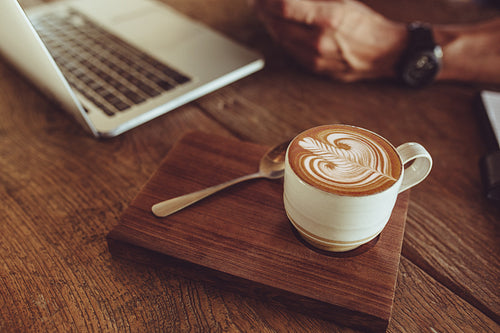 Coffee with latte art on cafe table