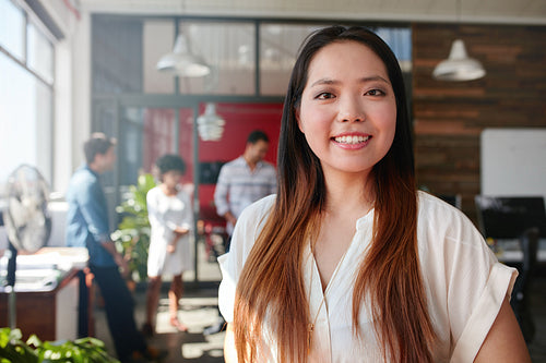 Smiling young businesswoman in office