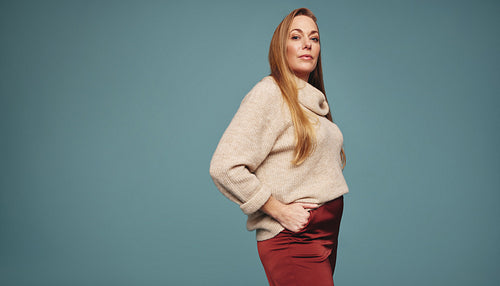 Blonde woman feeling empowered in a studio