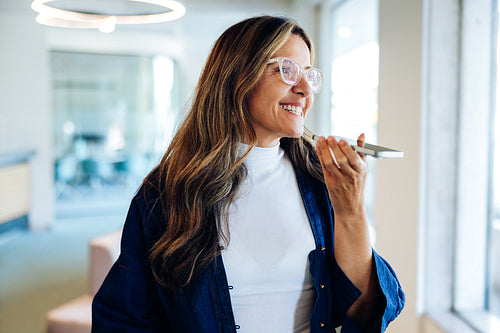 Business woman smiling in office on the phone