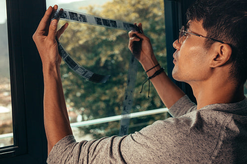 Photographer selecting a frame on old film