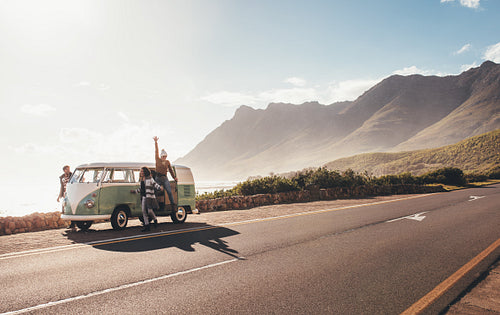 Friends on roadtrip hanging out by the road