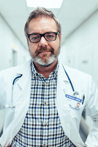Portrait of mature doctor standing in hospital