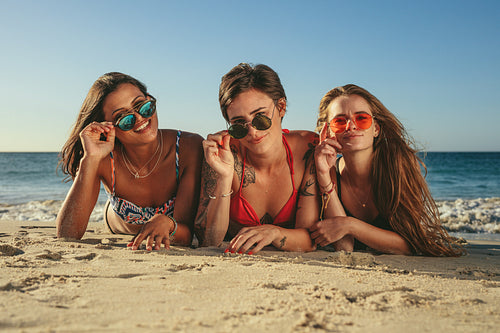 Woman friends sunbathing and enjoying at the beach