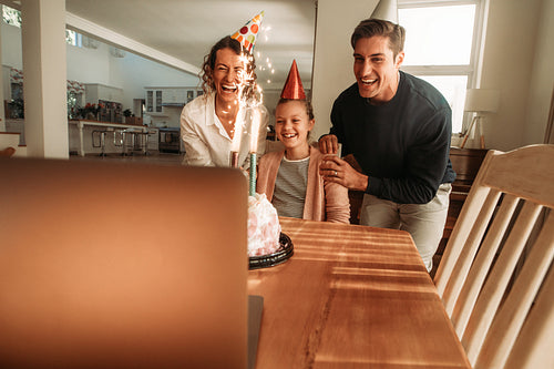 Family celebrating daughter's birthday online
