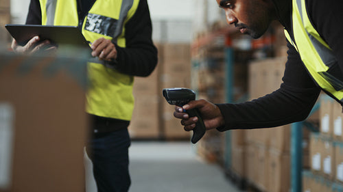 Barcode scanning in a warehouse: New employee receives training in inventory management