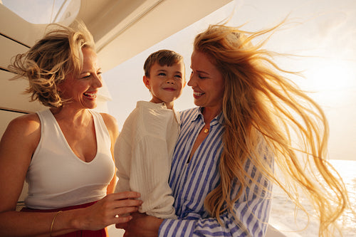 Generational sunset joy: Mother, grandmother, and child sharing a happy experience