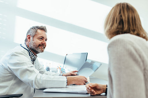 Doctor talking with patient during consultation