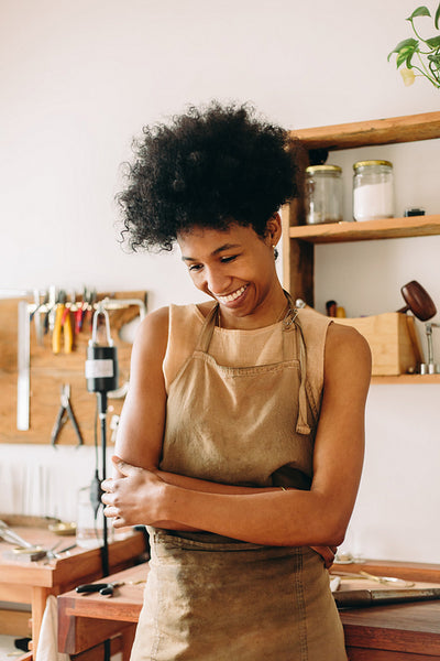 Happy jewelry designer at workshop