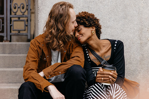 Affectionate couple sharing a tender moment on city steps