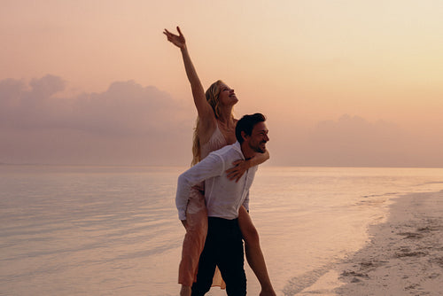 Romantic tropical destination wedding couple at sunset on the beach
