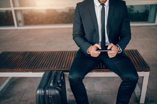 Businessman waiting in public transport station.