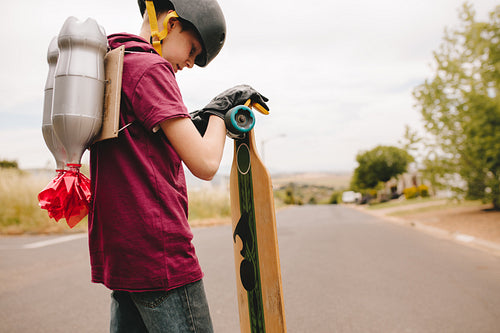 Boy with jetpack and skateboard